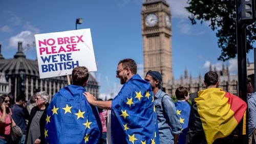 Men draped in European Union flags were among the tens of thousands this weekend demonstrating against Britain's vote to leave the union. (Andrew Testa/The New York Times)