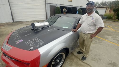 Clayton County resident Randy Gallop just finished a two-year project transforming the charred remains of a 2010 Chevrolet Camaro into a replica of the P-40 Warhawk airplane the famed WWII black flying squadron Tuskegee Airmen flew into battle. Gallop bought the car for $500, sunk $70,000 into it, adding a red tail, a shark teeth grill, WWII-style plane rivets and a souped-up engine that will eventually reach 2,000-horsepower. He plans to take the car around the country to collect 5,000 signatures from active and retired military vets in the five branches of service. So far, he has about 50 signatures, including a half-dozen from surviving Tuskegee airmen and their flight crew and a commitment for a two-star general’s signature. KENT D. JOHNSON/KDJOHNSON@AJC.COM