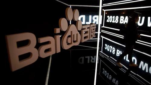 FILE - An attendee walks past a display at the Baidu World conference in Beijing, on Nov. 1, 2018. A top public relations executive from Chinese technology firm Baidu apologized Thursday, May 9, 2024, after she made comments in a series of videos that critics said glorified a culture of overwork. (AP Photo/Mark Schiefelbein, File)