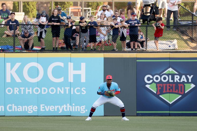 Fans crowd the right field fence as Atlanta Braves outfielder Ronald Acuna, who’s rehabbing with Triple-A Gwinnett, fields during the Gwinnett Stripers’ game against the Norfolk Tides at Coolray Field Wednesday, April 27, 2022, in Lawrenceville, Ga. (Jason Getz / Jason.Getz@ajc.com)