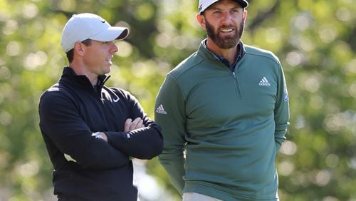 Rory McIIroy (left) and Dustin Johnson confer on the fourth tee during their practice round for the Masters at Augusta National Golf Club on Monday, April 5, 2021, in Augusta.  Curtis Compton / Curtis.Compton@ajc.com