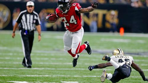 Atlanta Falcons running back Devonta Freeman (24) tries to avoid the tackle by New Orleans Saints cornerback Ken Crawley (46) in the first half of an NFL football game in New Orleans, Monday, Sept. 26, 2016. (AP Photo/Butch Dill)