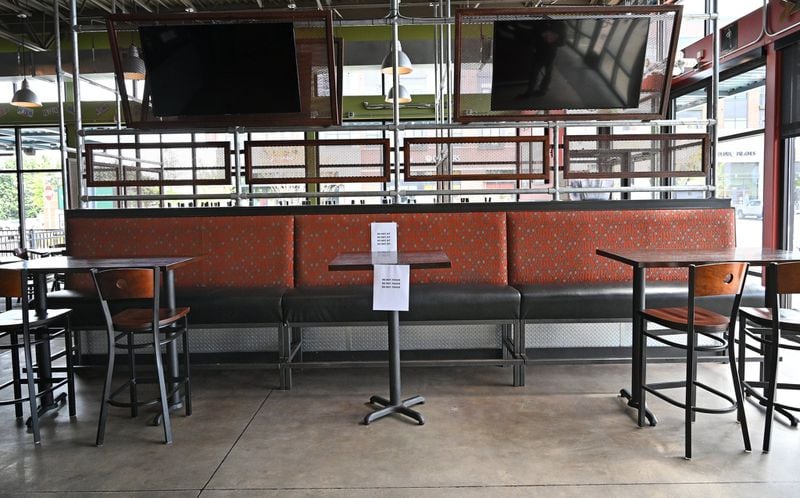 April 25, 2020 Decatur - As a part of social distance efforts, "Do Not Sit" signs were placed every other table as restaurant staff prepare to reopen the restaurant at Bad Daddy's Burger Bar in Decatur on Saturday, April 25, 2020. On Monday, Kemp announced shuttered businesses including barbershops, beauty and nail salons, spas, gyms and bowling alleys could reopen Friday. Movie theaters and restaurant dining rooms can reopen Monday. (Hyosub Shin / Hyosub.Shin@ajc.com)