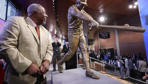 Hank Aaron views a new statue of him in Monument Grove at SunTrust Park. Baseball commissioner Rob Manfred, visiting Friday, said it might be the best baseball statue Manfred ever saw. (Curtis Compton/ccompton@ajc.com)