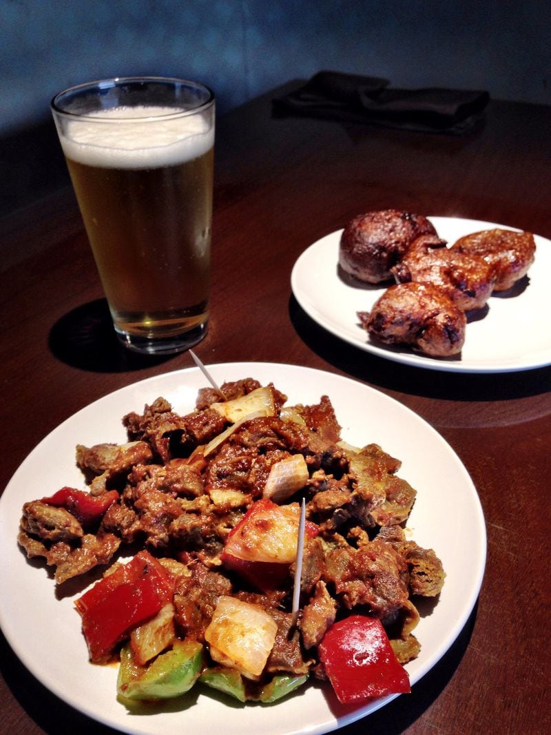 The spicy, stewed chicken gizzards and krakro (plantain dumplings) at Cafe Songhai pair well with beer. CONTRIBUTED BY WYATT WILLIAMS