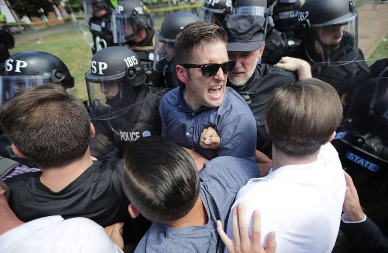 CHARLOTTESVILLE, VA - AUGUST 12:  White nationalist Richard Spencer (C) and his supporters clash with Virginia State Police in Emancipation Park after the "Unite the Right" rally was declared an unlawful gathering August 12, 2017 in Charlottesville, Virginia. Hundreds of white nationalists, neo-Nazis and members of the "alt-right" clashed with anti-fascist protesters and police as they attempted to hold a rally in Emancipation Park, where a statue of Confederate General Robert E. Lee is slated to be removed. 