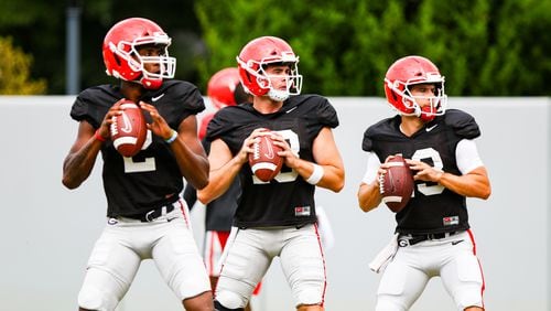 Georgia quarterbacks D'Wan Mathis (2), JT Daniels (18) and Stetson Bennett (13) get in some throwing time during the Bulldogs’ practice session Wednesday, Sept. 9, 2020, in Athens. (Tony Walsh/UGA Sports)