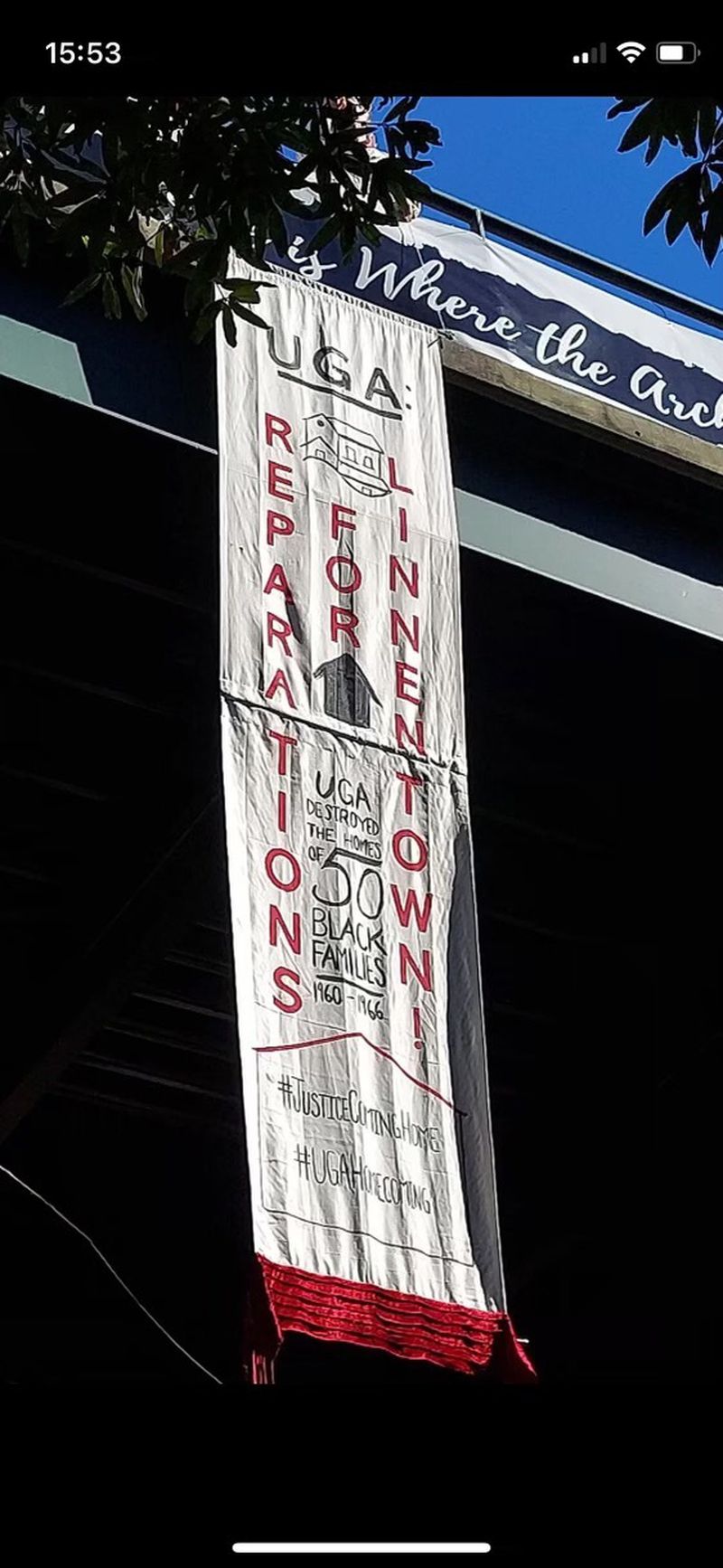 A small group of University of Georgia students flew this banner over a pathway leading to Sanford Stadium during the UGA-Kentucky game on Oct. 16, calling for reparations for Linnentown.
