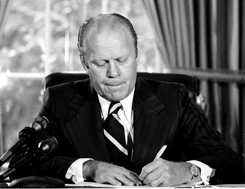 President Gerald Ford signs a document granting former President Richard M. Nixon "a full, free and absolute pardon" for all "offenses against the United States" during the period of his presidency in this Sept. 8, 1974 file photo in his White House office.    (AP Photo/File)