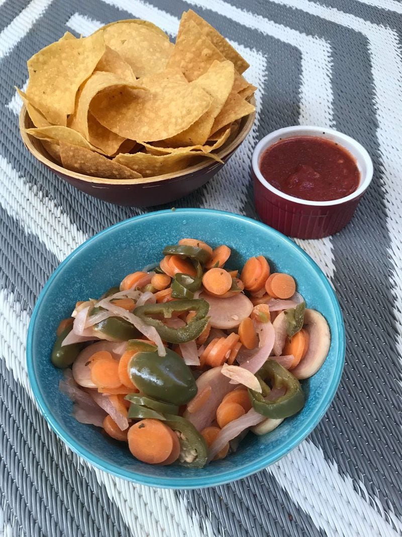 Round out your El Ponce meal with an order of escabeche (foreground), a spicy mix of pickled jalapeños, carrots, radishes and onions. All orders come with a serving of chips and house salsa. LIGAYA FIGUERAS / LIGAYA.FIGUERAS@AJC.COM