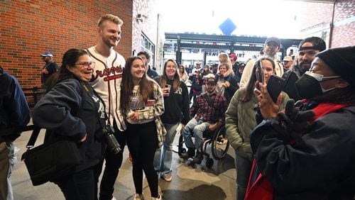 Braves pitcher Michael Soroka poses with fans during 2023 Braves Fan Fest at Truist Park, Saturday, Jan. 21, 2023, in Atlanta. After not holding the event for several years because of the pandemic, the team will bring back the fan event Saturday. Fan Fest will be held at Truist Park and The Battery Atlanta from 10 a.m. to 4 p.m. The free event will feature player autographs and photos, Q&A sessions, clinics, games, on-field activities, live entertainment and panel discussions with players and coaches. (Hyosub Shin / Hyosub.Shin@ajc.com)