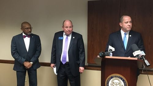 Dougherty County District Attorney Greg Edwards, GBI Director Vernon Keenan and Georgia Attorney General Chris Carr announce the arrests of three people Monday who allegedly took Medicaid funding from the elderly and housed them in poor conditions. MARK NIESSE/ MARK.NIESSE@AJC.COM