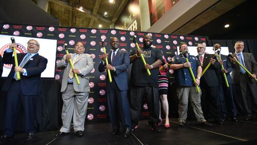 Atlanta Mayor Kasim Reed (center left), Killer Mike (center right) and other VIP guests pose with sledgehammers during a press conference announcing details of a $192.5 million update to Philips Arena in June. Fulton County Commission Chairman John Eaves was not in attendance. HYOSUB SHIN / HSHIN@AJC.COM
