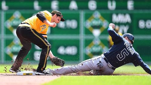 Freddie Freeman safely steals second base in front of the Pirates&#039; Phil Gosselin during Sunday&#039;s game.