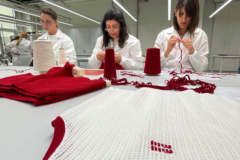 Italian artesans create knitwear for the Prada and Miu Miu brands at a recently expanded factory in the Perugia province of Italy Tuesday, May 7, 2024. The Prada Group is expanding its production footprint in Italy, including dozens of new jobs at brand's knitwear factory near Umbria, leaning into Made in Italy as integral to the brand's ethos as it develops new artisanal talent to ease the luxury group through a generational shift in its workforce, alongside the management and creative transitions already under way. (AP Photo/Colleen Barry)