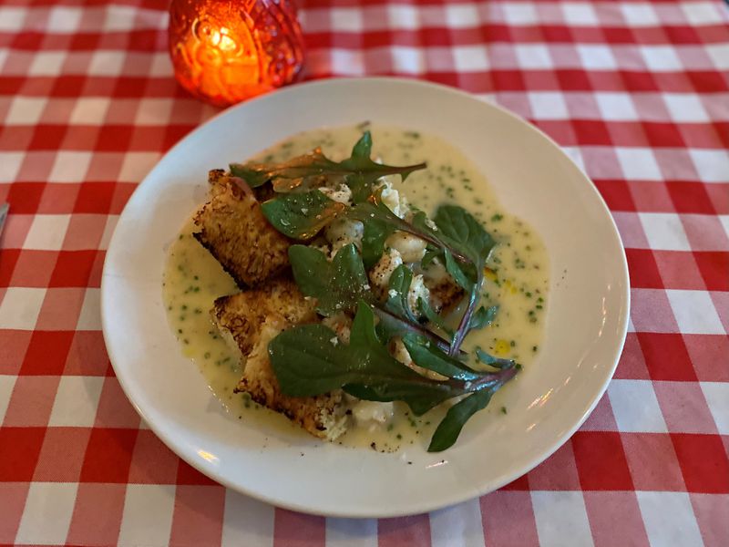 Gigi’s Italian Kitchen & Restaurant sometimes riffs on classics — like this shrimp scampi with focaccia and red-veined spinach.
Wendell Brock for The Atlanta Journal-Constitution