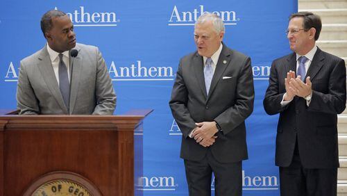 Gov. Nathan Deal (center) receives acknowledgment from Atlanta Mayor Kasim Reed (left) and Anthem Senior Vice President and Chief Information Officer Tom Miller. Health care giant Anthem plans an 1,800-job expansion at Bank of America Plaza in Atlanta, company and political leaders said Wednesday. The parent of Blue Cross/Blue Shield of Georgia said the jobs involved will be mainly in software development. BOB ANDRES /BANDRES@AJC.COM