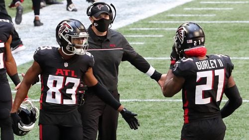 Falcons head coach Dan Quinn and wide receiver Russell Gage greet running back Todd Gurley after his touchdown cut the lead to 14-9 against the Seattle Seahawks during the second quarter Sunday, Sept. 13, 2020, in Atlanta.  (Curtis Compton / Curtis.Compton@ajc.com)