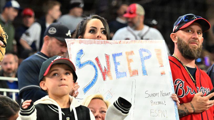 Braves fan holds a sign during against the Mets at Truist Park on Sunday, Oct. 2, 2022. (Hyosub Shin / Hyosub.Shin@ajc.com)