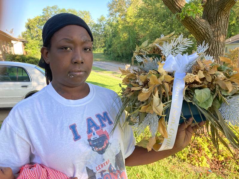 FILE - Ericka Lotts holds a bouquet from the funeral of her son, Derontae Martin, Sept. 17, 2021, at her home in Ferguson, Mo. Martin died of a self-inflicted gunshot wound inside a rural Missouri home, not at the hands of the white homeowner who had a history of racist social media postings, an FBI official told The Associated Press on Wednesday, April 24, 2024. (AP Photo/Jim Salter, File)