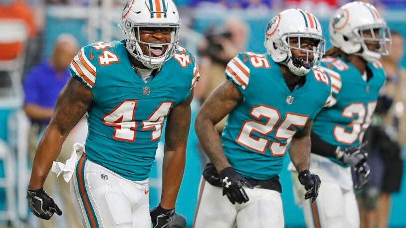 Miami Dolphins outside linebacker Stephone Anthony (44) celebrates after stopping Buffalo Bills fullback Mike Tolbert from getting a first down in the second quarter at the Hard Rock Stadium in Miami Gardens, Fla., on Sunday, Dec. 31, 2017. The Bills won, 22-16. (Al Diaz/Miami Herald/TNS)