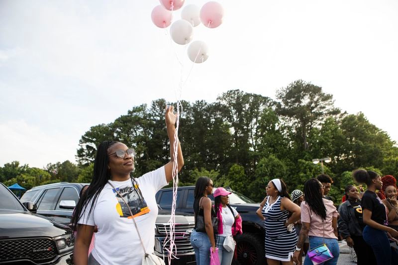 Marian Simmons, the godmother of shooting victim Bre'Asia Powell, releases balloons during an event honoring Powell on Wednesday, May 31, 2023, at the C.T. Martin Natatorium and Recreation Center in Atlanta. Powell was killed on Memorial Day weekend at a gathering at Benjamin E. Mays High School, which she attended. CHRISTINA MATACOTTA FOR THE ATLANTA JOURNAL-CONSTITUTION.