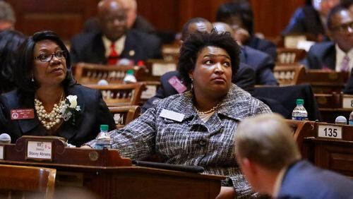 State Rep. Carolyn Hugley (left), D - Columbus, and then-House Minority Leader Stacey Abrams cast a vote. BOB ANDRES  / BANDRES@AJC.COM