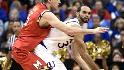 Kansas forward Perry Ellis (34) is guarded by Maryland forward Michal Cekovsky (15) during the first half of an NCAA college basketball game in the regional semifinals of the men's NCAA Tournament in Louisville, Ky., Thursday, March 24, 2016. (AP Photo/John Flavell)