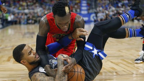 Atlanta Hawks guard Dennis Schroder, top, fights for the ball with Orlando Magic guard D.J. Augustin during the second half of an NBA basketball game in Orlando, Fla., Saturday, Feb. 25, 2017. (AP Photo/Reinhold Matay)