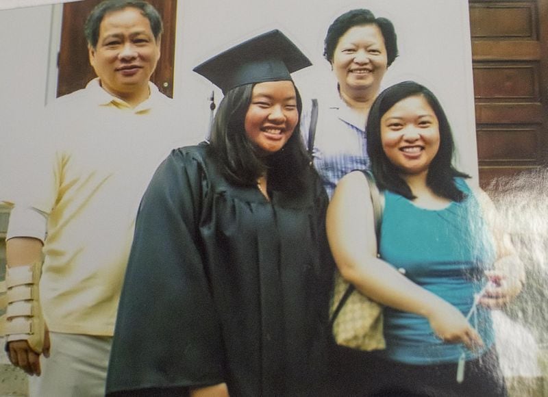 A photograph of Wendy Hsiao (second from left) and her family on the day of her graduation from the University of Georgia in 2009 is displayed in her Atlanta office. Even after seven college internships, Hsiao struggled to find a job in public relations during the recession. (Alyssa Pointer/alyssa.pointer@ajc.com)