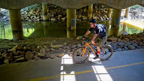 April 12, 2014 Alpharetta - Ken Gilbert rides his bike down the path of the Big Creek Greenway in Alpharetta on Saturday, April 12, 2014. JONATHAN PHILLIPS / SPECIAL