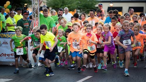 Young runners sporting all sorts of glow-in-the-dark accessories will be part of this year’s “Light up the Corners” evening run in Peachtree Corners. Contributed by David Winters