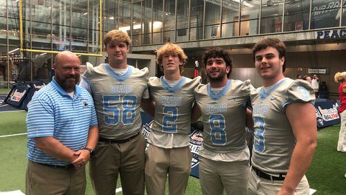 Cambridge coach Craig Bennett with his top players on the 2022 team: Tommy Broderick (58), Will Taylor (2), Jack Marlow (8) and Brooks Morley (3)