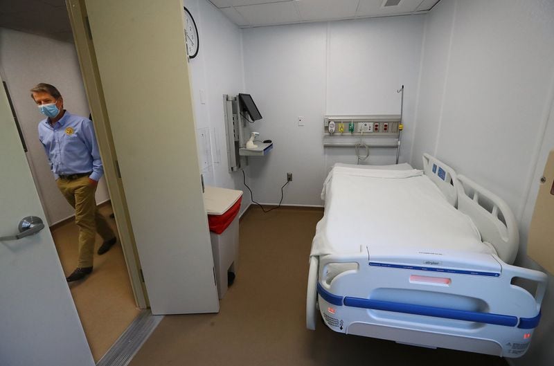 Gov. Brian Kemp passes by a patient room while touring the temporary medical pod that has been placed at the North Campus of Phoebe Putney Health System on Tuesday, May 5, 2020, in Albany. The pod is scheduled to begin operations on Wednesday, May 6, housing 24 beds to treat non-critical COVID-19 patients. (CURTIS COMPTON / ccompton@ajc.com)