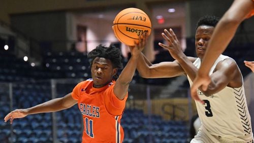 Columbia's Kawasiki Ricks (11) and Pace Academy's Madison Durr (3) fight for a loose ball during the 2021 GHSA State Basketball Class AA Boys Championship game at the Macon Centreplex in Macon on Thursday, March 11, 2021 Pace Academy won 73-42 over Columbia.