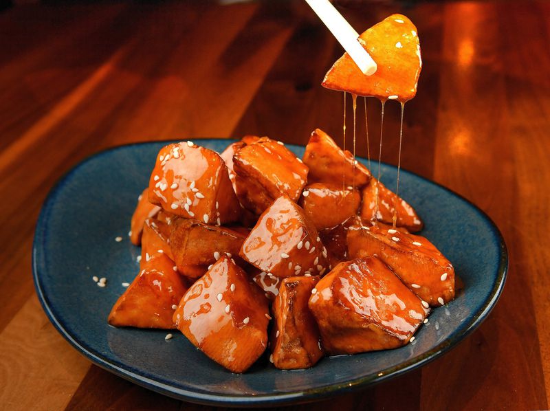 Candied Sweet Potato (Ba Si Di Gua), from a recipe by executive chef Xue Guo Wu of Buckhead restaurant Urban Wu, can serve as a dessert for a Lunar New Year’s celebration. CONTRIBUTED BY CHRIS HUNT PHOTOGRAPHY