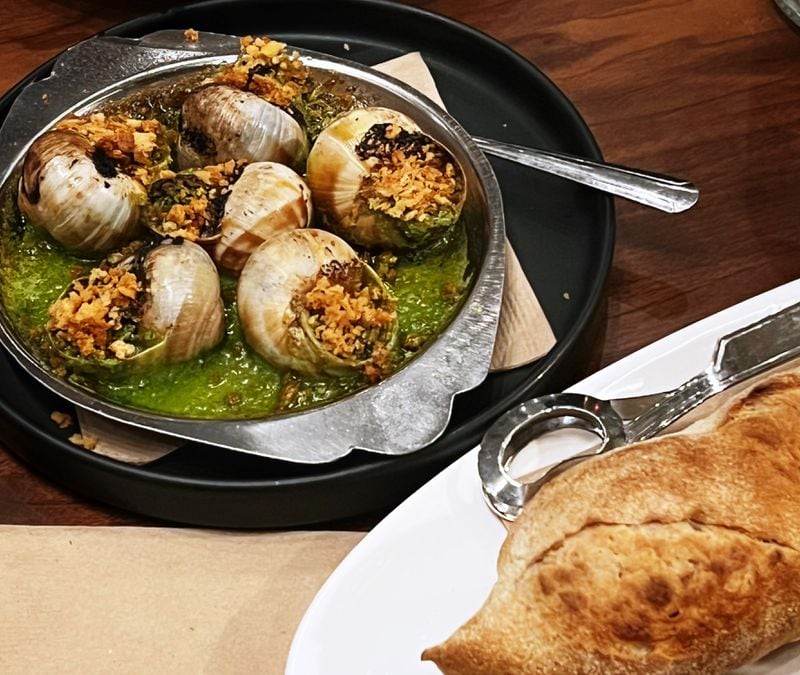 Escargots served with a demi-baguette are an example of Foundation Social Eatery's approach to French cooking. Henri Hollis/henry.hollis@ajc.com