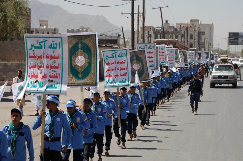 Yemeni students carry anti-Israel and anti-U.S. banners during a march organized by Houthis, to show solidarity with Palestinians in the Gaza Strip, in Sanaa, Yemen, Sunday, May 5, 2024. The Arabic reads, "God is great, Death to Israel, Death to America". (AP Photo/Osamah Abdulrahman)