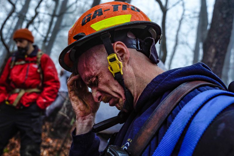 A rescue team member was emotional after finding the hiker's body near a creek.