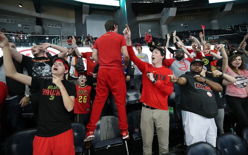 Adnan Ikic climbs on his chair (back to camera) to lead a cheer in the 6th Man Section while the Hawks battle for a 104-90 victory over the Utah Jazz in an NBA game on Jan. 22, 2018, in Atlanta. CURTIS COMPTON / CCOMPTON@AJC.COM
