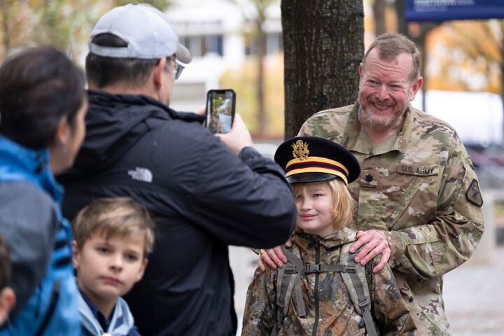 Lt. Col. Brad Carver poses for a photo with his son Bradley, 11, while watching the 42nd annual Georgia Veteran’s Day Parade in Midtown Atlanta on Saturday, Nov. 11, 2023.   (Ben Gray / Ben@BenGray.com)