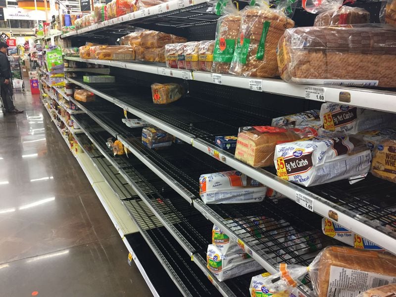 The bread aisle at a Kroger store in Peachtree City late Thursday shows the same pre-storm decimation that was common across the metro area.