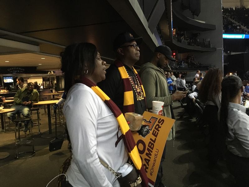 Doretha and Donald Ingram, parents of Loyola-Chicago guard Donte Ingram, watch the Kentucky-Kansas State game at Philips Arena Thursday night after Loyola had already advanced to the Elite 8 with its win over Nevada. Dorethan said that a fan offered her $100 for her scarf.