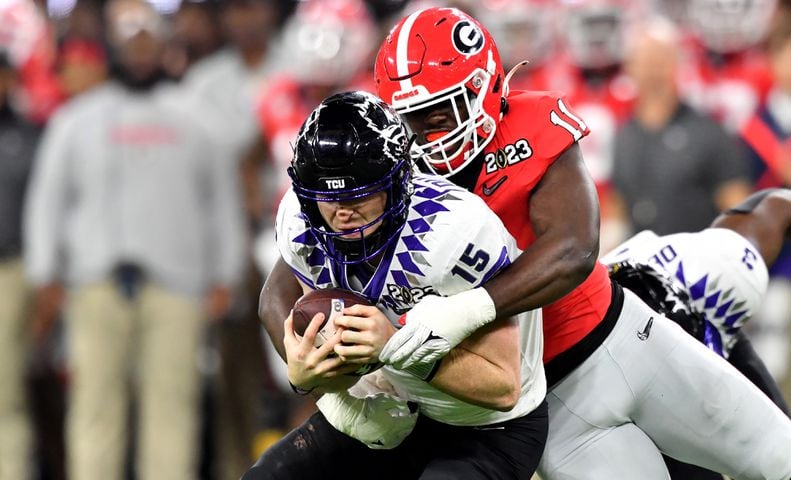 Georgia Bulldogs linebacker Jalon Walker (11) sacks TCU Horned Frogs quarterback Max Duggan (15) during the second half of the College Football Playoff National Championship at SoFi Stadium in Los Angeles on Monday, January 9, 2023. Georgia won 65-7 and secured a back-to-back championship. (Hyosub Shin / Hyosub.Shin@ajc.com)