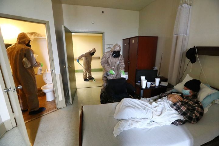 April 19, 2020 Atlanta: Members of the Georgia Army National Guard infection control team with the 265th Chemical Battalion compassionately disinfect the room of a resident at Legacy Transitional Care and the hallway while disinfecting the facility on Sunday, April 19, 2020, in Atlanta.   Curtis Compton ccompton@ajc.com