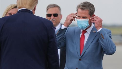 Georgia Gov. Brian Kemp, right, greets President Donald Trump as he visits Georgia to talk about an infrastructure overhaul at the UPS Hapeville hub at Hartsfield-Jackson International Airport in Atlanta on Wednesday, July 15, 2020. (Curtis Compton/Atlanta Journal-Constitution/TNS) 