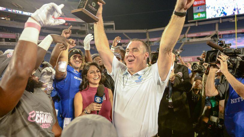 Georgia State coach Shawn Elliott holds the Cure Bowl trophy after the Panthers defeated the Western Kentucky Hilltoppers 27-17 on Dec. 16 in Orlando. It was the program's first bowl win.