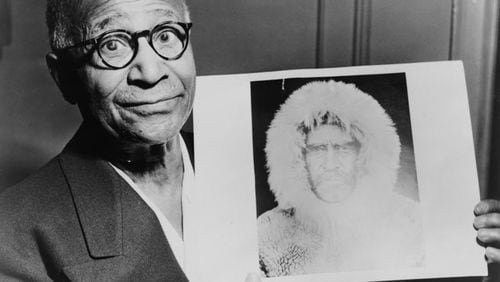 Matthew Henson, explorer, in 1953 holding a portrait of Robert E. Peary taken during an expedition to the North Pole. (World-Telegram photo by Roger Higgins / courtesy of Library of Congress)