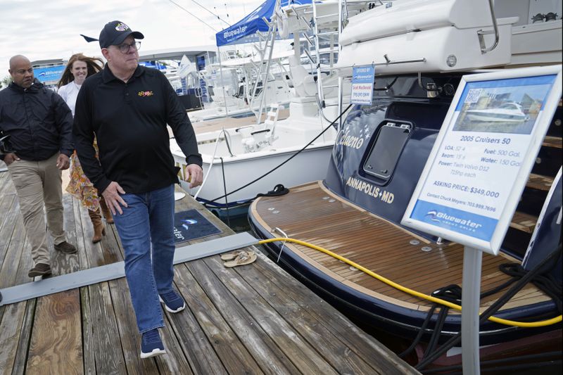 Former Maryland Gov. Larry Hogan visits the Bridge Boat Show in Stevensville, Md., Friday, April 12, 2024, as he campaigns for the U.S. Senate. (AP Photo/Susan Walsh)