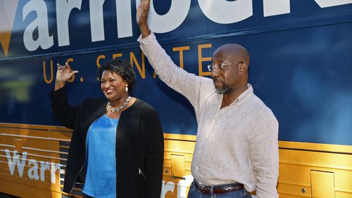 Democratic gubernatorial nominee Stacey Abrams and Democratic U.S. Sen. Raphael Warnock greets supporters during a campaign stop Wednesday at the Cobb County Civic Center. (Jason Getz / Jason.Getz@ajc.com)